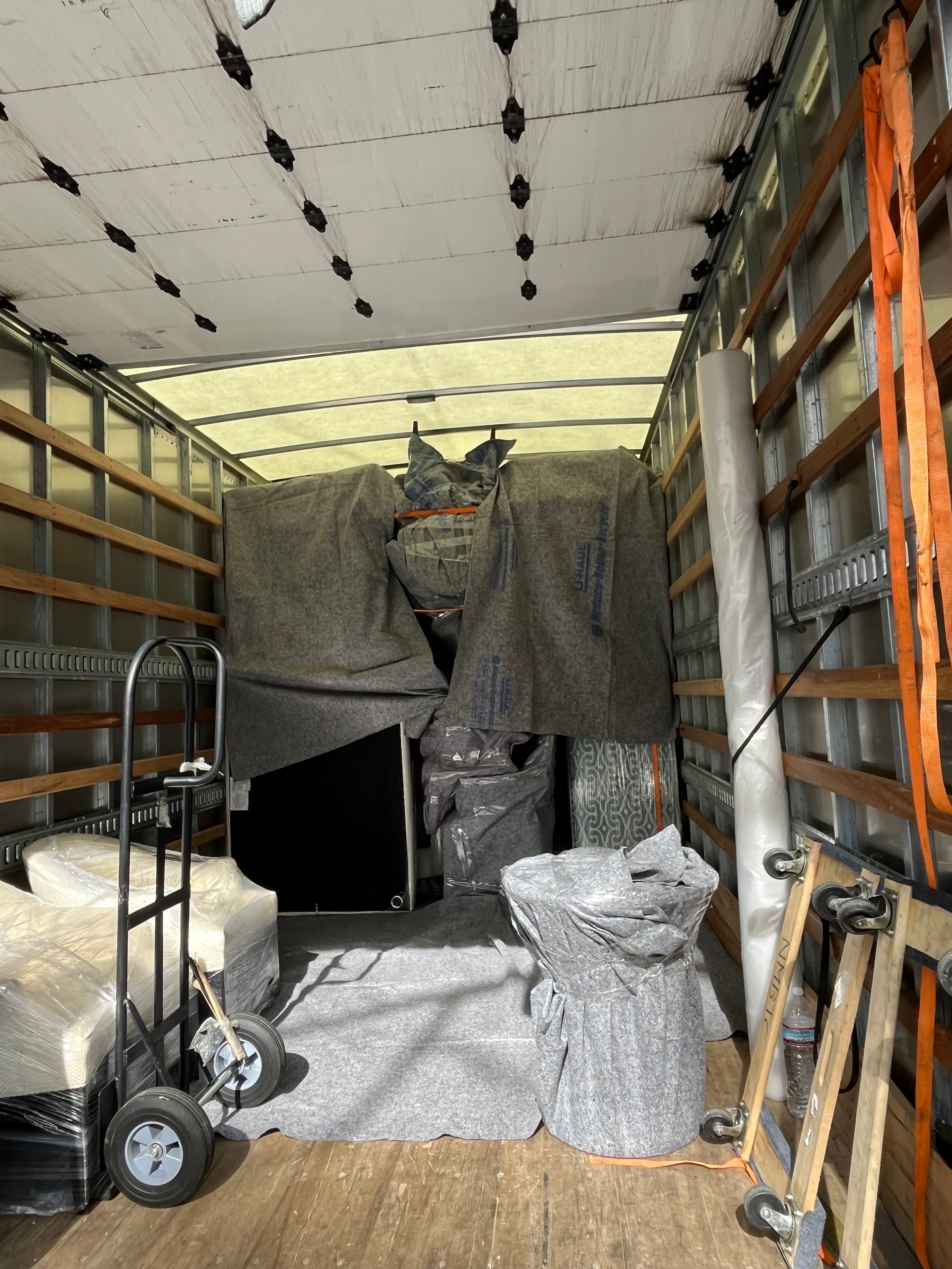 Piano being carefully moved by professional crew